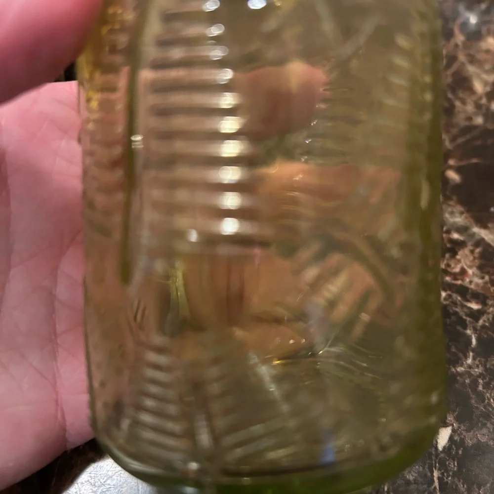 yellow iridescent glass vase with a leaf etching